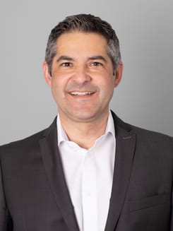 Professionelles GLKB-Porträt vor grauem Hintergrund.