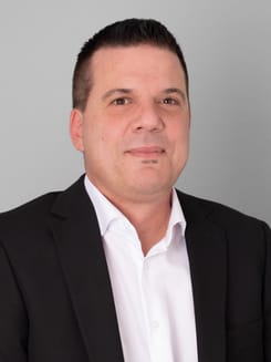 Professionelles GLKB-Porträt vor grauem Hintergrund.