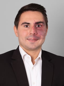 Professionelles GLKB-Porträt vor grauem Hintergrund.