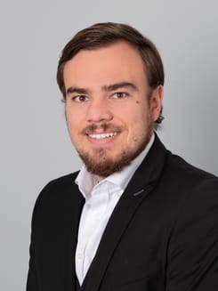 Professionelles GLKB-Porträt vor grauem Hintergrund.